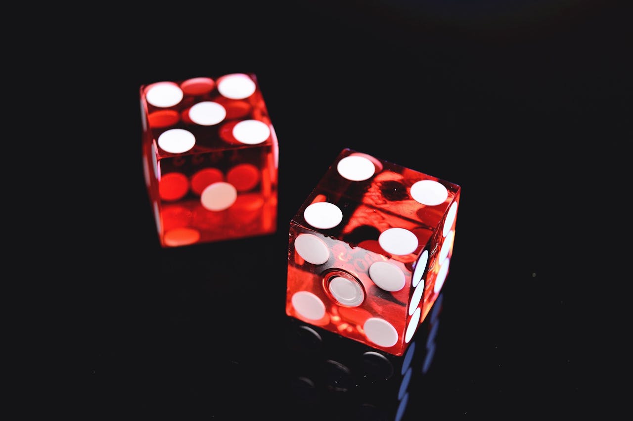Two red dice on a black background