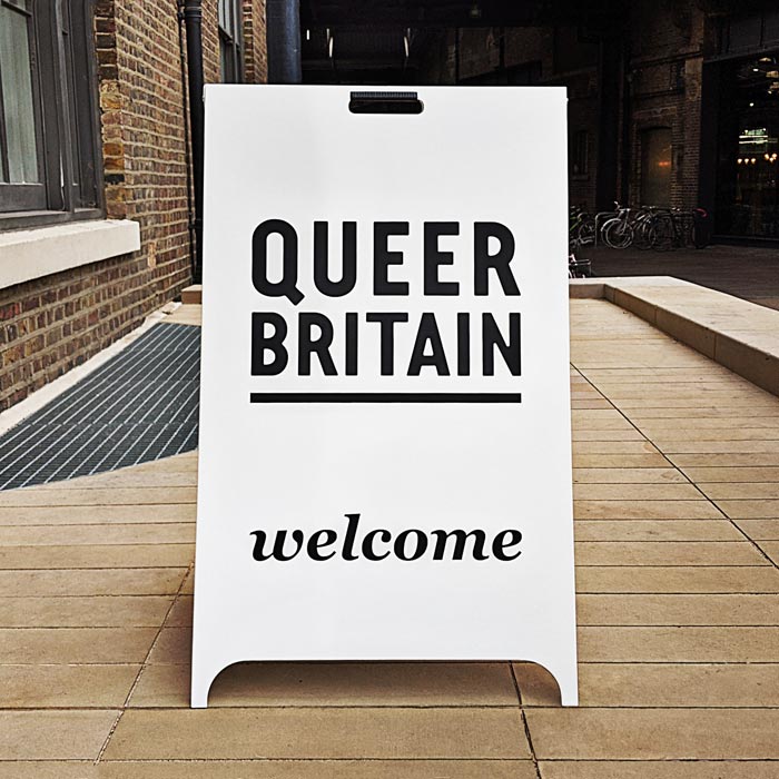 Queer Britain A-Board with 'welcome' text at the bototm.