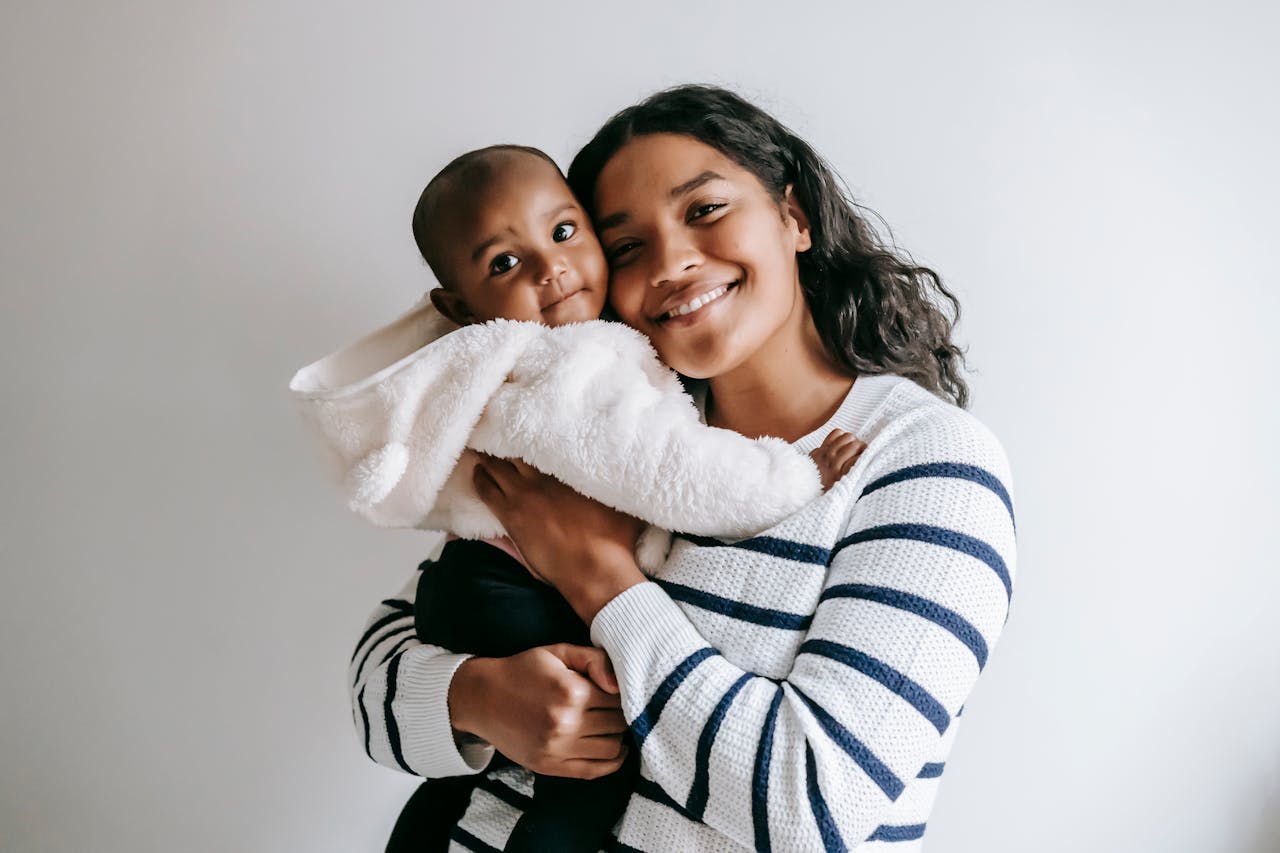 Mum holding a baby and smiling