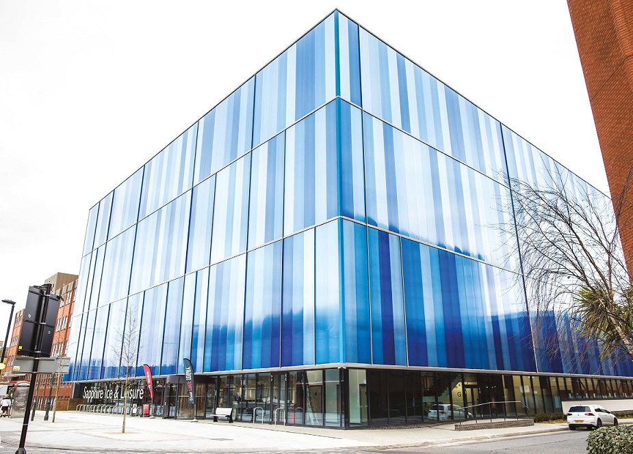 sapphire_ice_and_leisure_award_web Modern multi-story leisure centre with a blue glass facade and vertical stripes, and signage reading 'Sapphire Ice & Leisure'