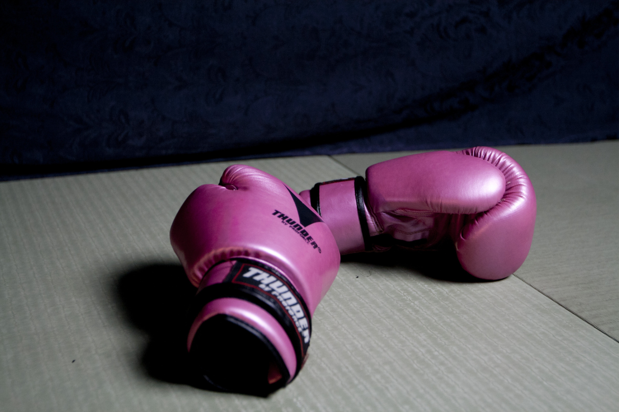 Two pink boxing gloves on a grey box